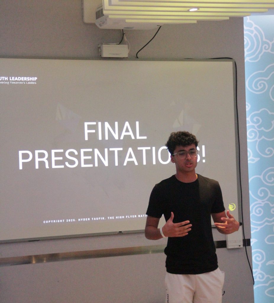 A youth participant public speaking for youth delivering a presentation on stage at a public speaking event.