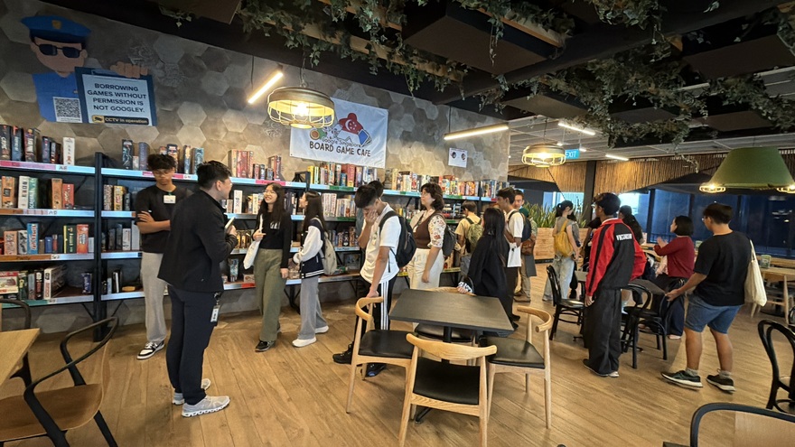 People browsing shelves of board games at the Google Singapore Board Game Cafe
