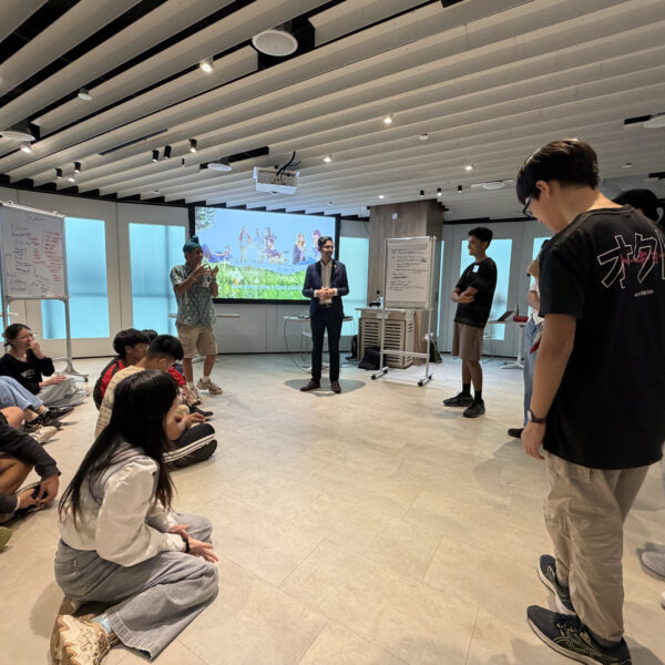 Students participating in a group workshop activity in a modern classroom setting in Youth Leadership and Communication Camp