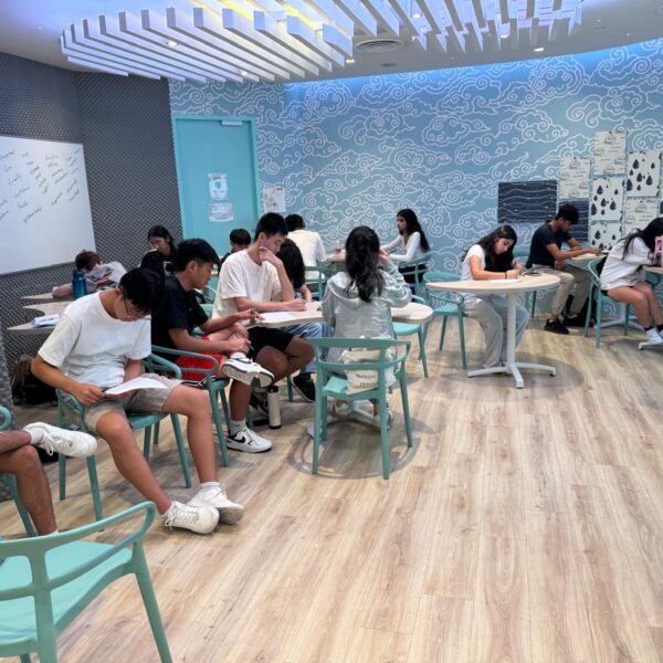 Students working on assignments in a modern classroom at Youth Leadership and Communication Camp